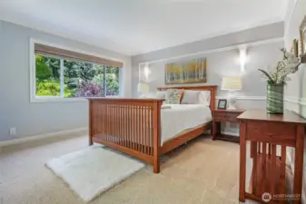 The primary bedroom is on the upper level and features custom millwork and moldings. Crown molding creates a sophisticated look.