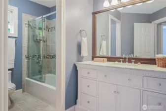 The full bath with upgraded vanity and marble counter, is conveniently located in the hall near the bedrooms.