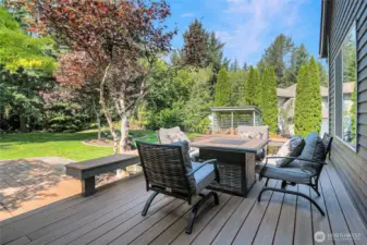 The uncovered area of the trex-style deck with built-in bench seating.