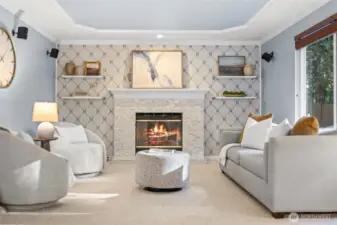 Cozy family room anchored by a gas fireplace.