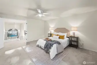 Just upstairs, french doors open up to the large primary suite.