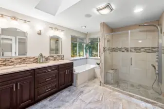 Ensuite bathroom includes dual sinks, soaking tub, large walk-in shower, toilet is in separate room off to the right of shower.