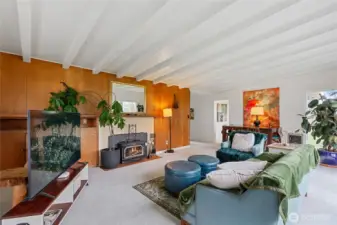 Spacious warm inviting open living and dining area with fireplace.