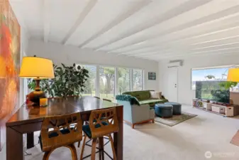 Spacious warm inviting open living and dining area with fireplace.