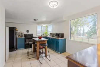 open, eat-in kitchen with large picture windows