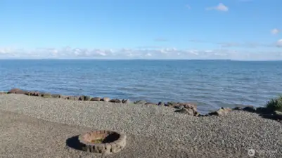 Firepit and steps down to the water's edge.
