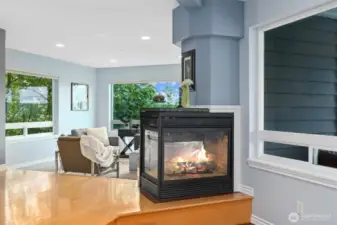 Gas fireplace connects living and dining rooms