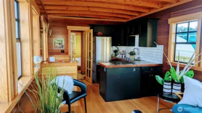 Living room w/ coved fir ceilings, fir floors and mahogany walls.