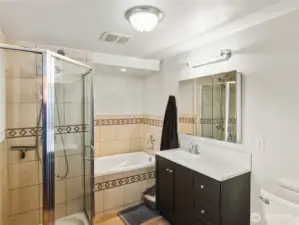 Primary ensuite bathroom includes a walk in shower and soaking tub