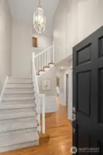 Open the door to a vaulted entry, freshly painted interior with new carpets.