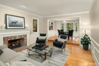 The living room continues the design style throughout the main floor featuring wainscotting, crown molding and attractive trim details.