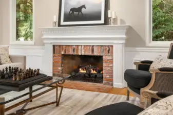 The living room continues the design style throughout the main floor featuring wainscotting, crown molding and attractive trim details.