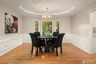 The dining room features a coved ceiling and views to the back yard.