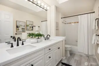 Updated hall bathroom with quartz countertops, new sinks, hardware and faucets.