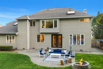 Exceptional Outdoor Living - step outside to a perfectly level, fully fenced backyard oasis designed for gathering and relaxation. A spacious patio and custom stone fire pit invite year-round enjoyment, while an impressive playhouse adds charm and imagination to the setting. The serene natural backdrop provides both privacy and a rare sense of connection to nature.