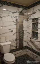 Shower room with 400 lb flip down shower chair.  Plumbing has been all redone.