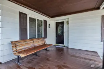 Covered porch at the formal entry from the street into the spacious foyer. Room for sitting bench, coat tree etc.