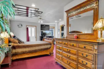 Just up a short flight of stairs is an enormous primary bedroom with a door to its own balcony