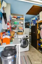 Laundry area off the kitchen doubles as a pantry/storage and houses freezer and a second refrigerator ...no need to go back into the kitchen to bring out snacks or cold drinks to the patio or hot tub. Note attic access on the ceiling.