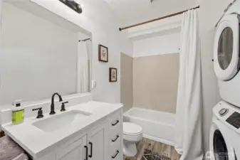 Full Bathroom / Utility Room  Barn door entrance  Quartz counters    Stackable washer and Dryer    Storage shelves    Storage area