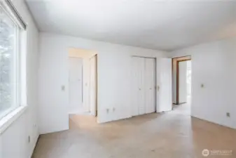 2 closets in the primary suite with a separate mirror/sink area from the toilet/shower