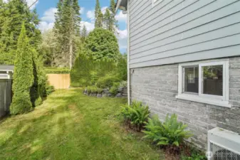 Side yard with fence onto street. Was once a driveway. Potential to reinstate & use as separate driveway/ RV parking to basement entrance.