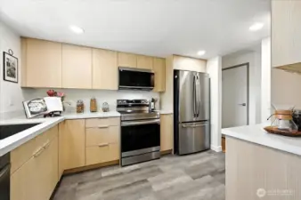New cupboards with quartz countertops. Desirable luxury vinyl plank makes this kitchen complete.