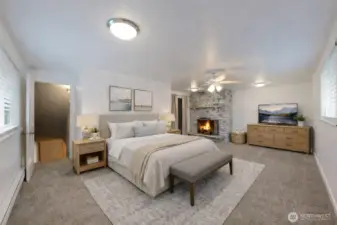 Primary suite is a private retreat with its own fireplace and a large walk-in closet. The photo is virtually staged.
