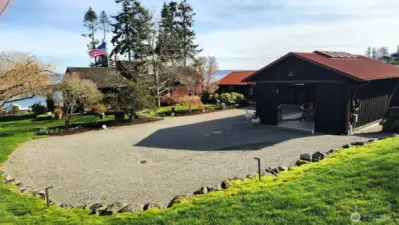 A slightly different angle for this photograph meant to give another perspective.  The garage and workshop are cedar sided, and finished in the unique Japanese Yakisugi or “shou sugi ban” finish.  Google it!  The 2 buildings are beautiful, built in 2017, and are turn-key for your artisan and trade productions!