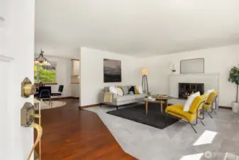 Open family room with brick, gas fireplace.