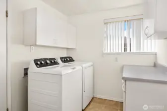 Spacious laundry room with lots of storage between Living Room and Garage.