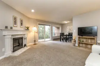 Open concept living area with fireplace feature, neutral décor, and flexible layout for furniture and media setup.