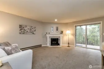 Cozy living room with updated fireplace surround and warm lighting, perfect for relaxing evenings.