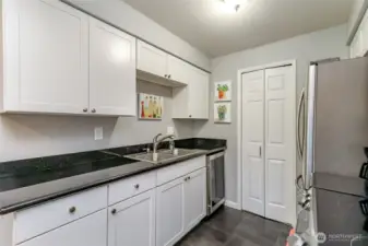 Kitchen with granite countertops, double sink, and ample cabinet storage for everyday use.