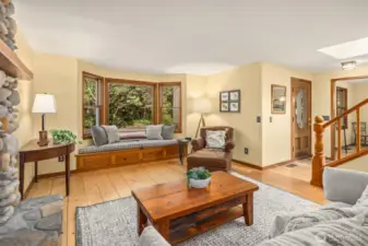 A look at the living room and home entrance. Notice the unique wood floors.