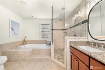 Primary ensuite with tub, walk in shower, and a double vanity