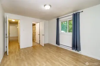 Primary bedroom with half bath and walk-in closet.