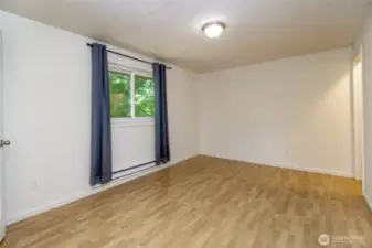 Primary bedroom with half bath and walk-in closet.
