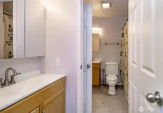 Primary bedroom half bath looking to main bath.