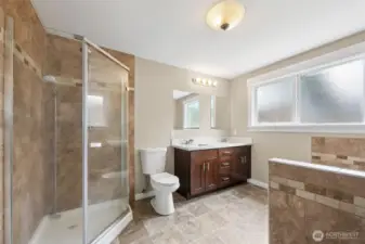 Primary bath has a standing shower, dual vanity, and a separate tub!