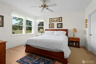 At the end of the hallway is the spacious primary room.  Behind the door is one of two walk-in closets.
