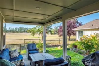 For your outdoor enjoyment is this covered porch with a view of the golf course.