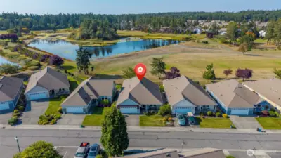 Aerial view of home in Whidbey Green with the Whidbey Golf Course in the background.