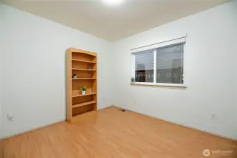 One of three bedrooms. Wood laminate flooring.