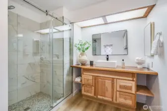Nice roomy step in shower and an updated vanity.