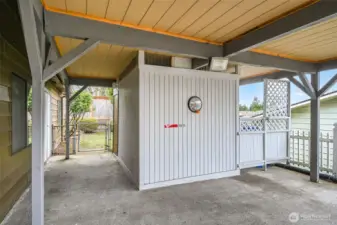 A great storage unit holds your tools and toys. The garbage is cleverly tucked away in it's own fenced spot