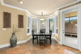 Breakfast nook seamlessly connected to the backyard patio with a built-in gas grill—ideal for indoor-outdoor entertaining.