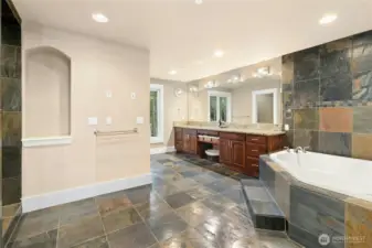 Elegant primary bathroom offering dual vanities and generous custom cabinetry for exceptional storage.