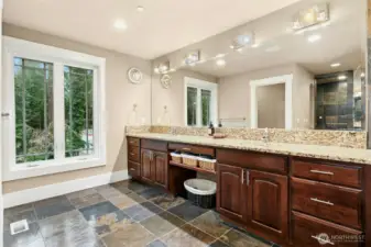 Elegant primary bathroom offering dual vanities and generous custom cabinetry for exceptional storage.