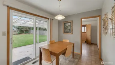 Kitchen and dining area drenched in natural sunlight.